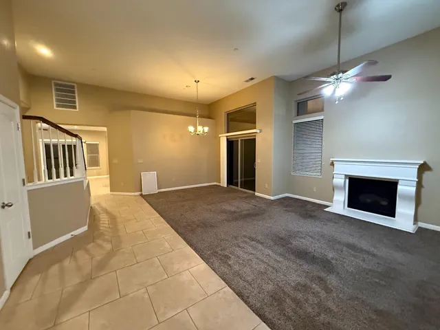a view of an empty room with window and fireplace
