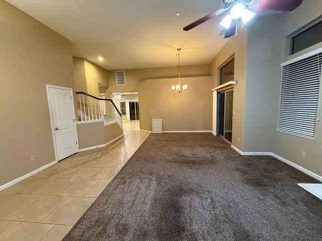 a view of an empty room with a fireplace and a window