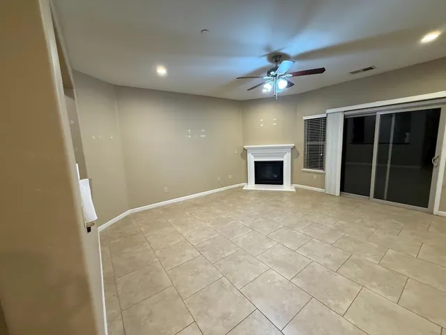 a large kitchen with granite countertop a large counter top and stainless steel appliances