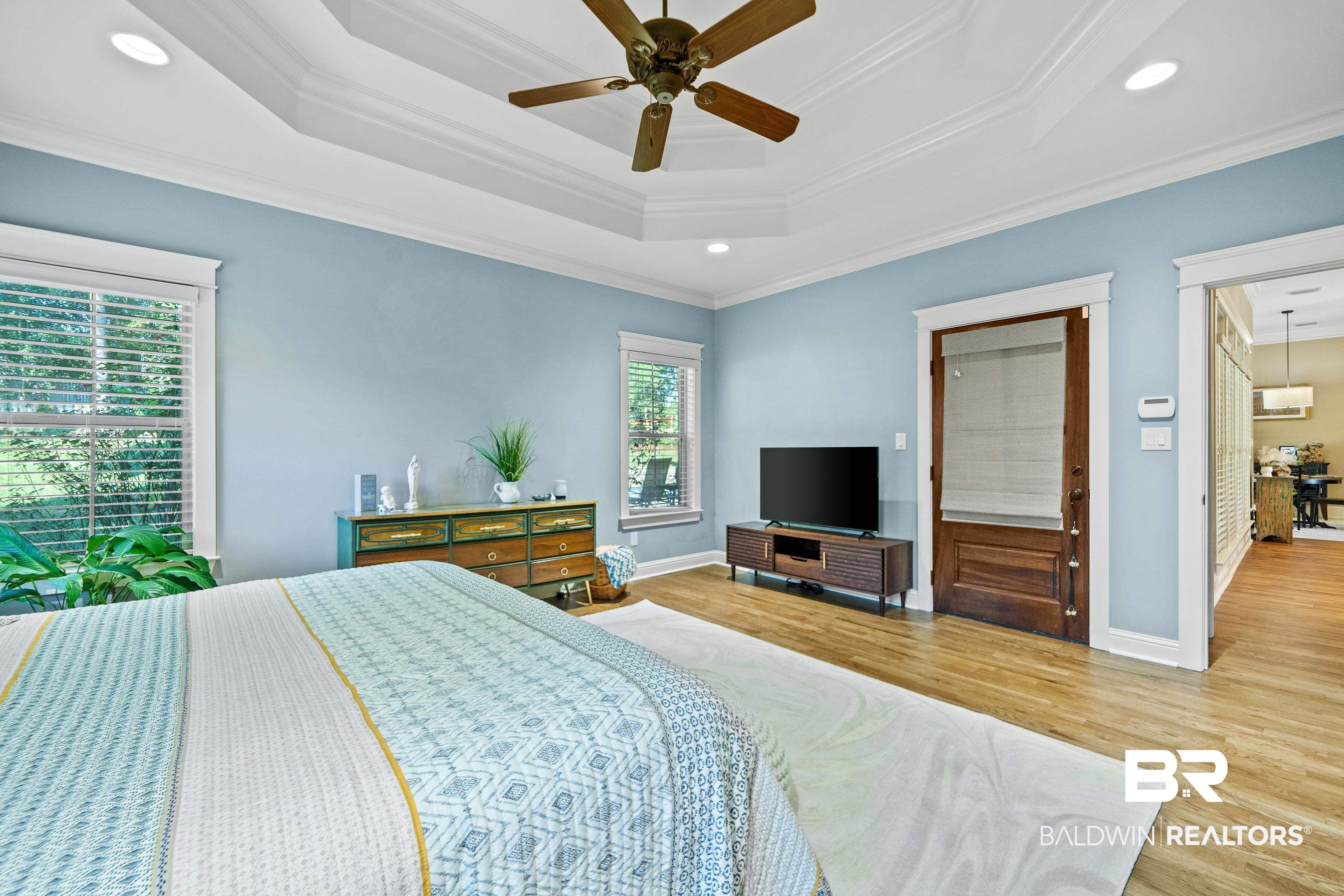 31829 Butler Drive Daphne, AL 36527 - Photo 22 of 48 Bedroom featuring ceiling fan, light hardwood / wood-style floors, ornamental molding, and multiple windows