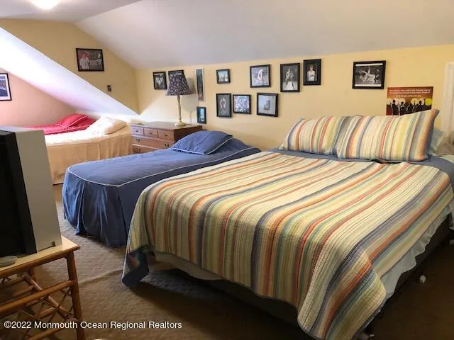 a bedroom with a bed and glass window