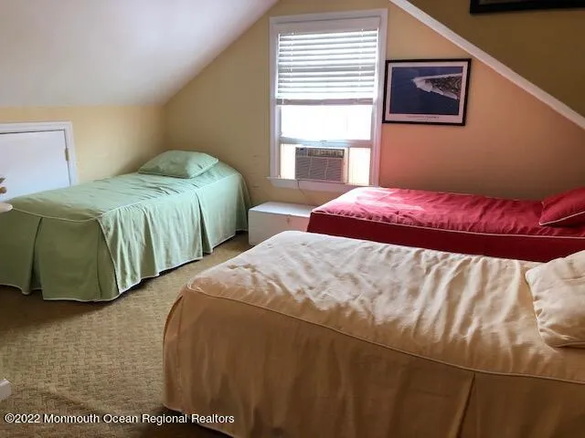 a bedroom with two beds and a window
