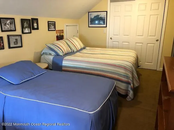 a bedroom with a bed and cupboard