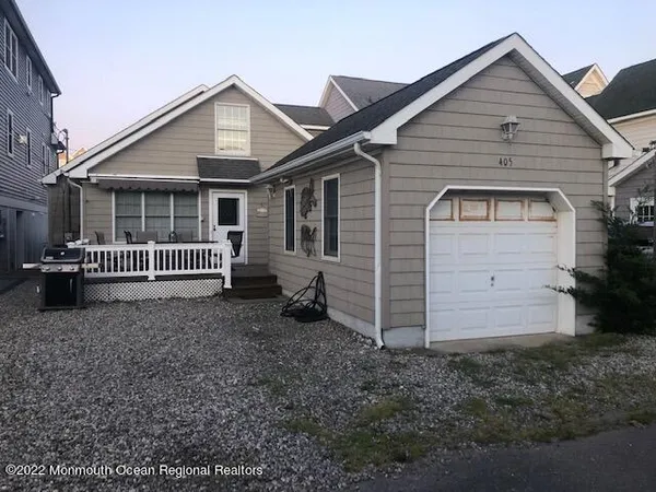 a view of a house with a yard and wooden fence