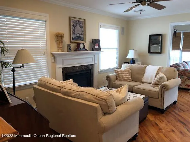 a living room with furniture a window and a fireplace