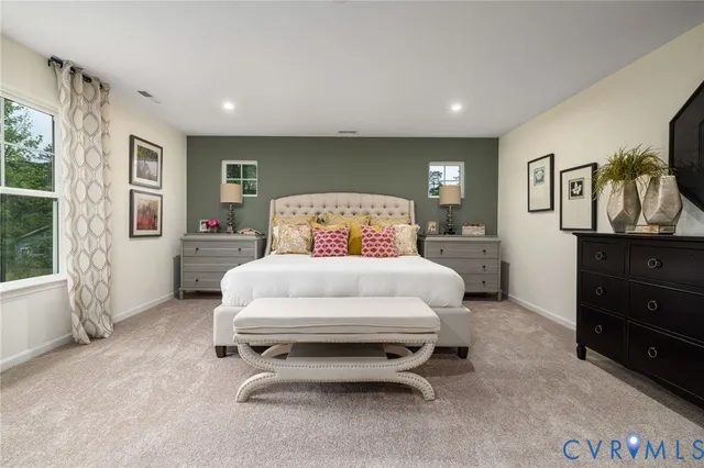 a bedroom with a bed and a large window