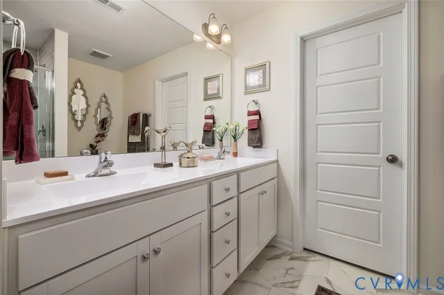 a bathroom with a shower and a sink