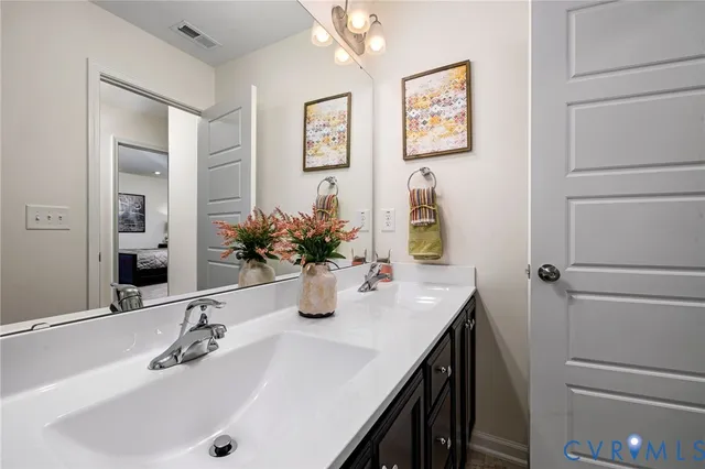 a bedroom with a bed couch and a window