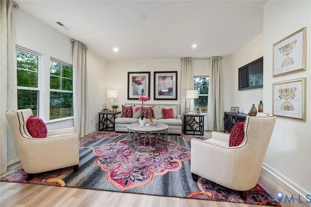a living room with furniture and a rug