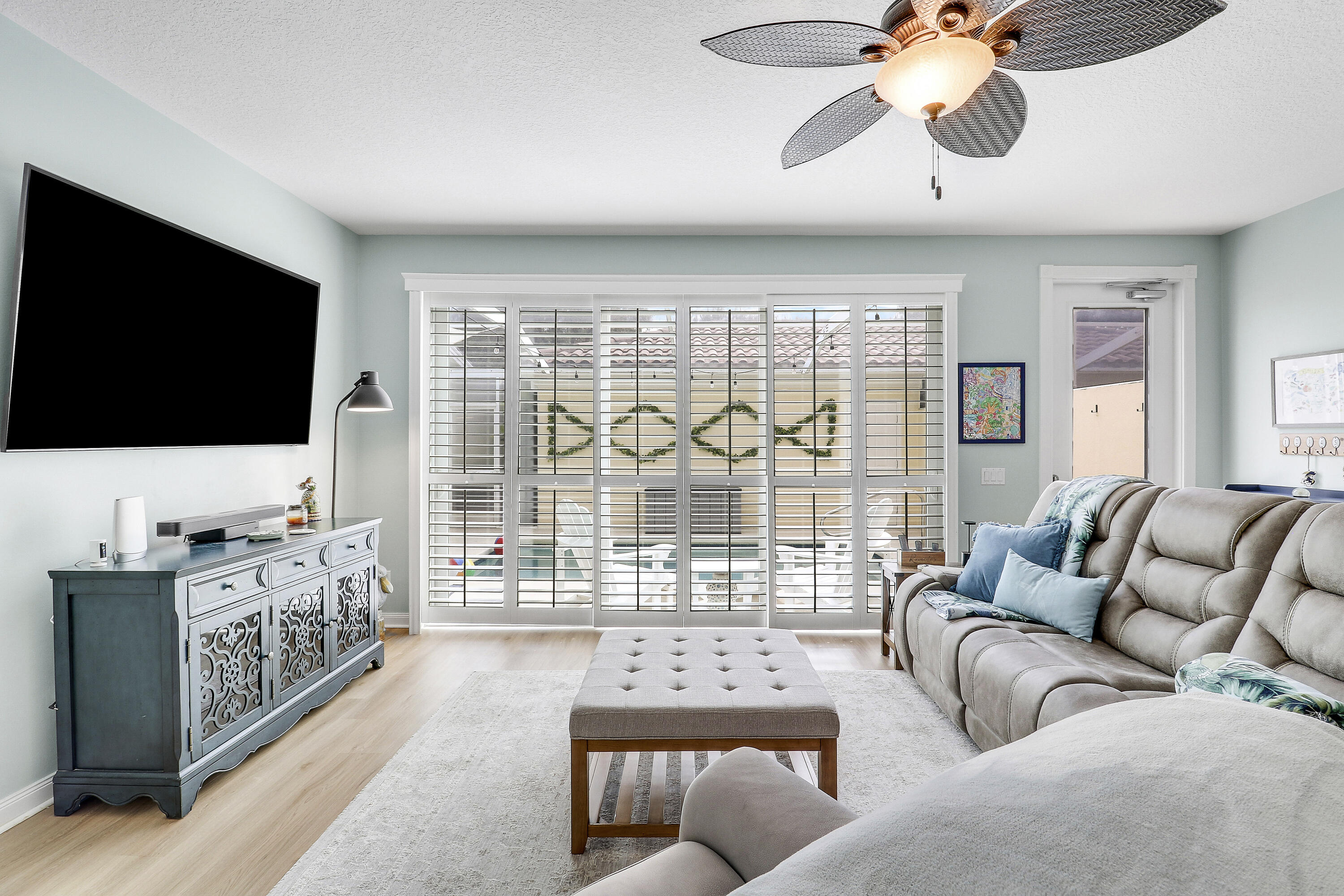 151 Rivinia Drive Jupiter, FL 33458 - Photo 13 of 40 a living room with furniture a flat screen tv and a large window