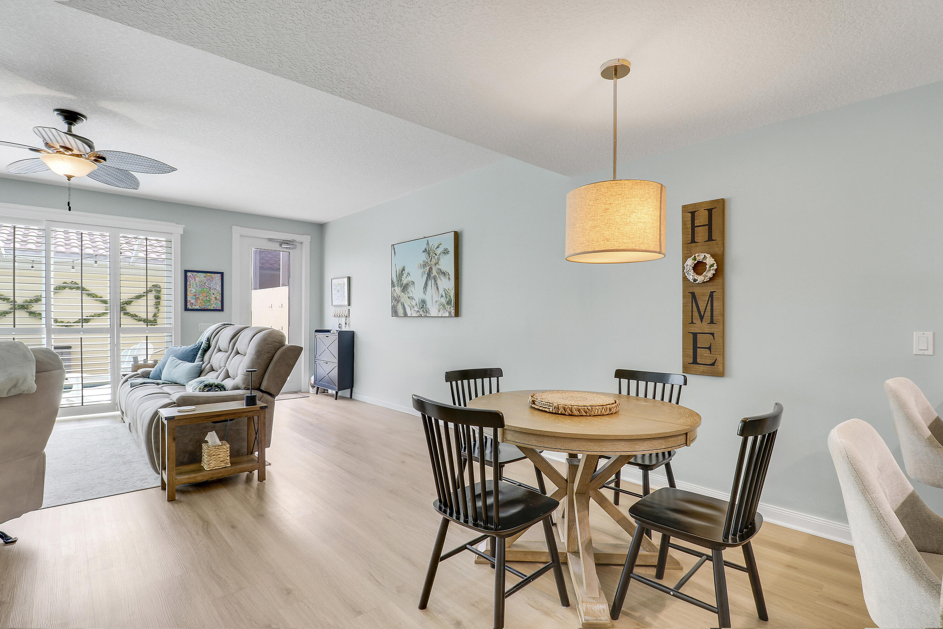 151 Rivinia Drive Jupiter, FL 33458 - Photo 14 of 40 a dining room with furniture a chandelier and wooden floor