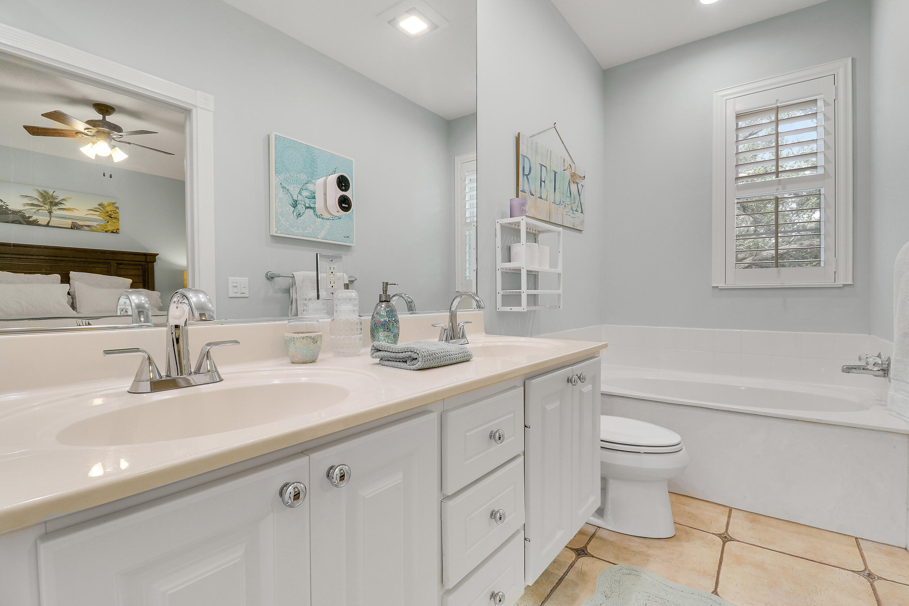 151 Rivinia Drive Jupiter, FL 33458 - Photo 23 of 40 a bathroom with a double vanity sink a toilet and a bathtub
