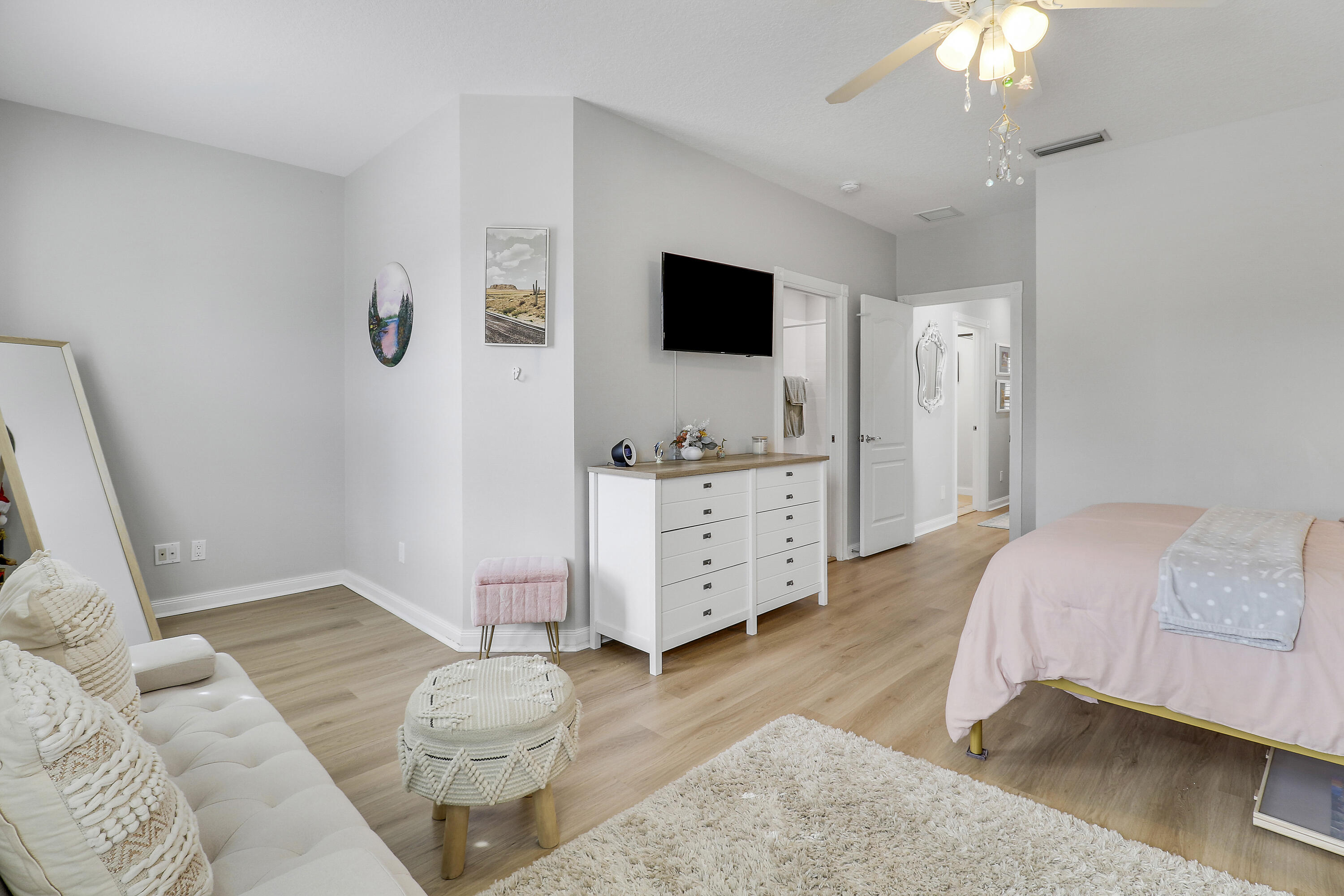 151 Rivinia Drive Jupiter, FL 33458 - Photo 28 of 40 a spacious bedroom with a bed and a flat tv screen on the dresser