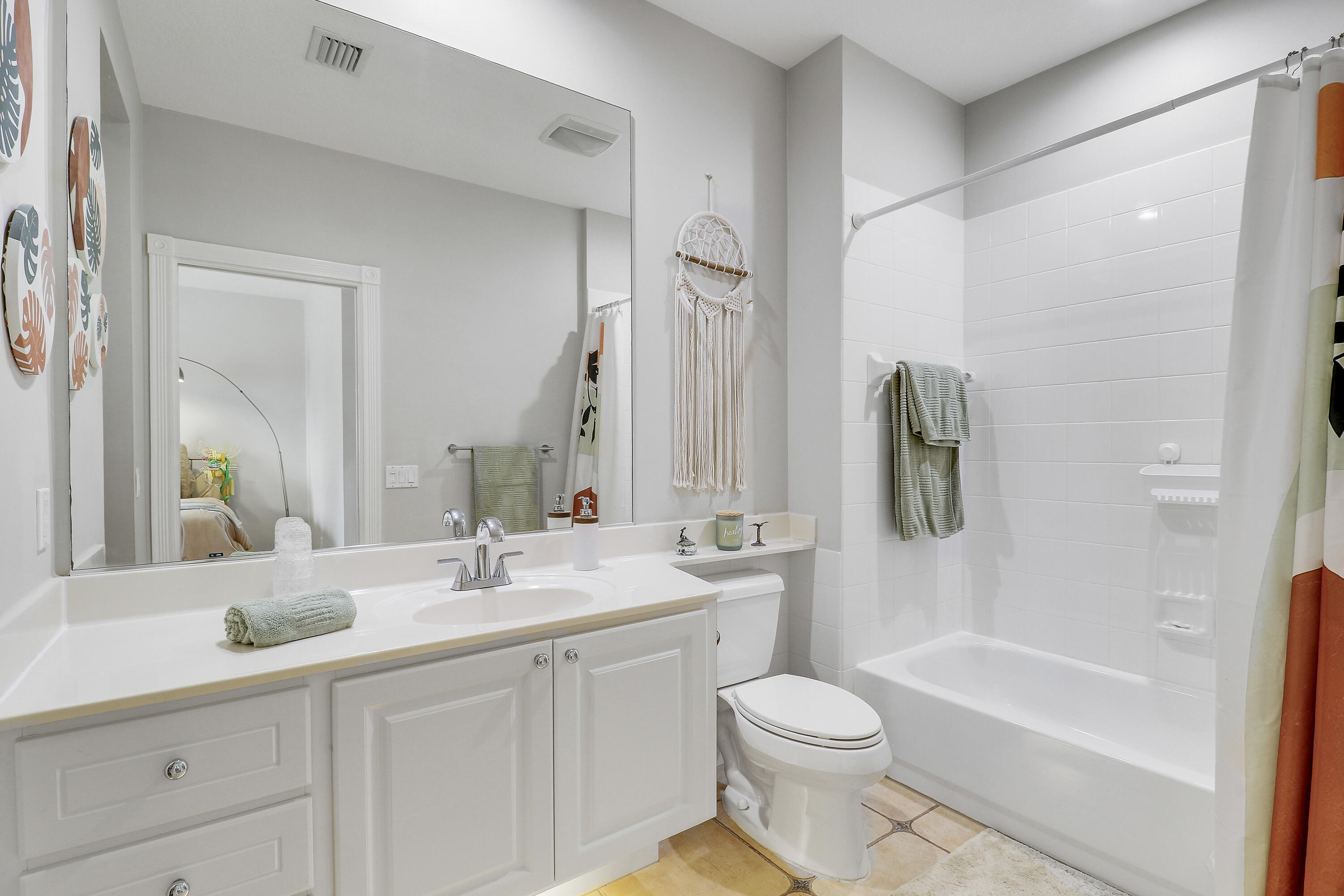 151 Rivinia Drive Jupiter, FL 33458 - Photo 30 of 40 a bathroom with a double vanity sink toilet mirror and bathtub