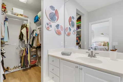 a bathroom with a sink mirror and vanity