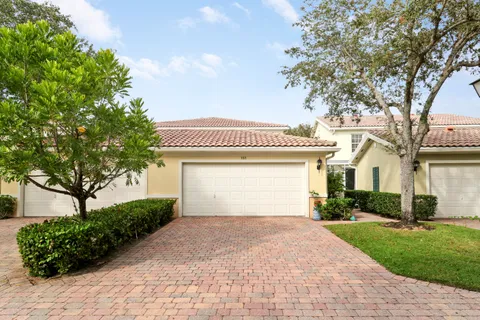 a front view of a house with a yard and a garage