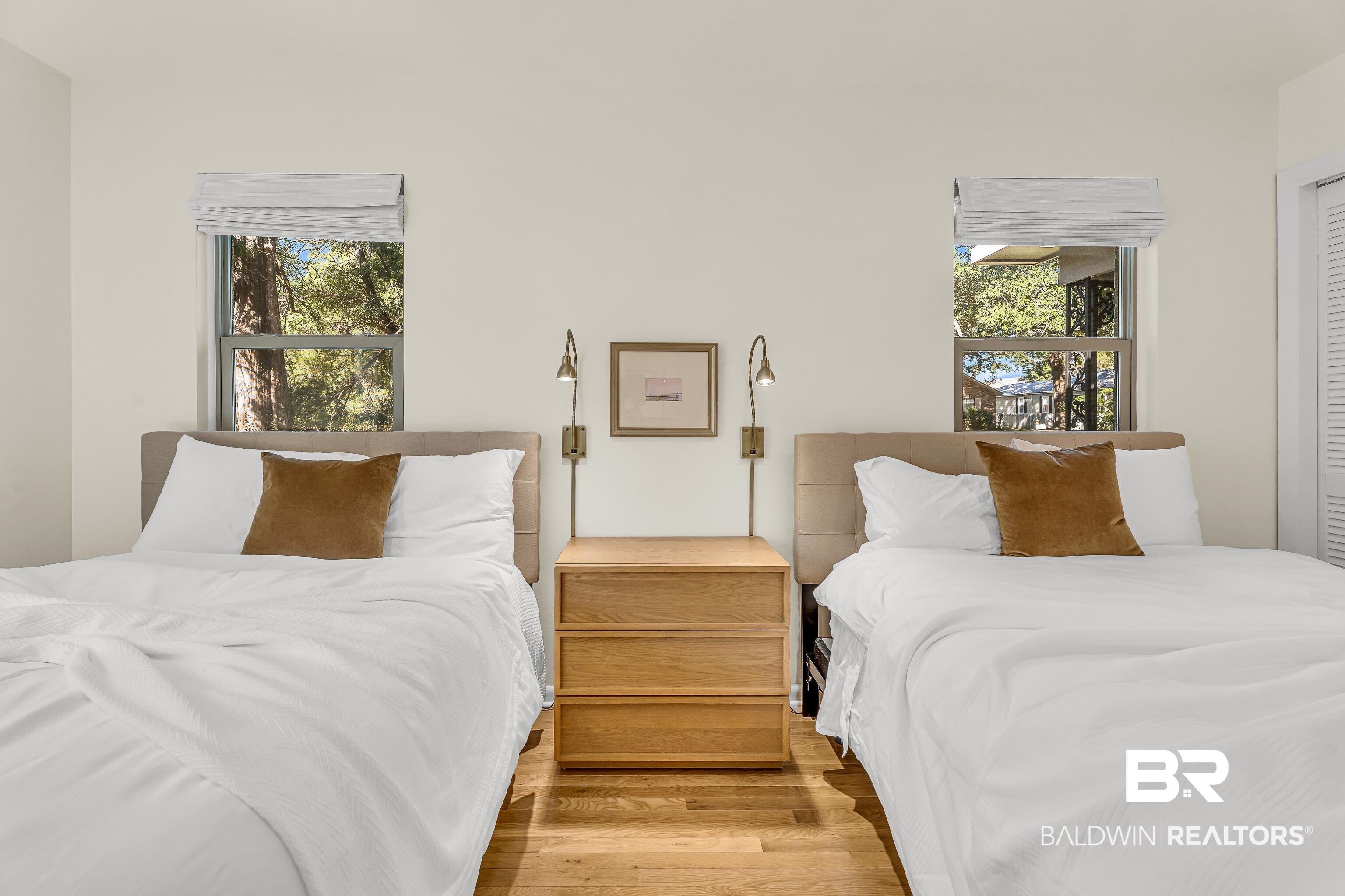 357 Azalea Street Fairhope, AL 36532 - Photo 13 of 22 Bedroom featuring wood finished floors and multiple windows