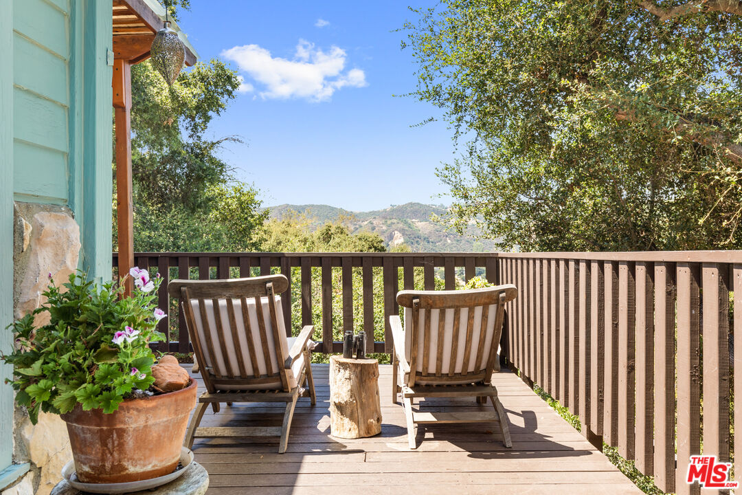 1553 Penny Road Topanga, CA 90290 - Photo 13 of 23 a view of a chair and table on the wooden floor