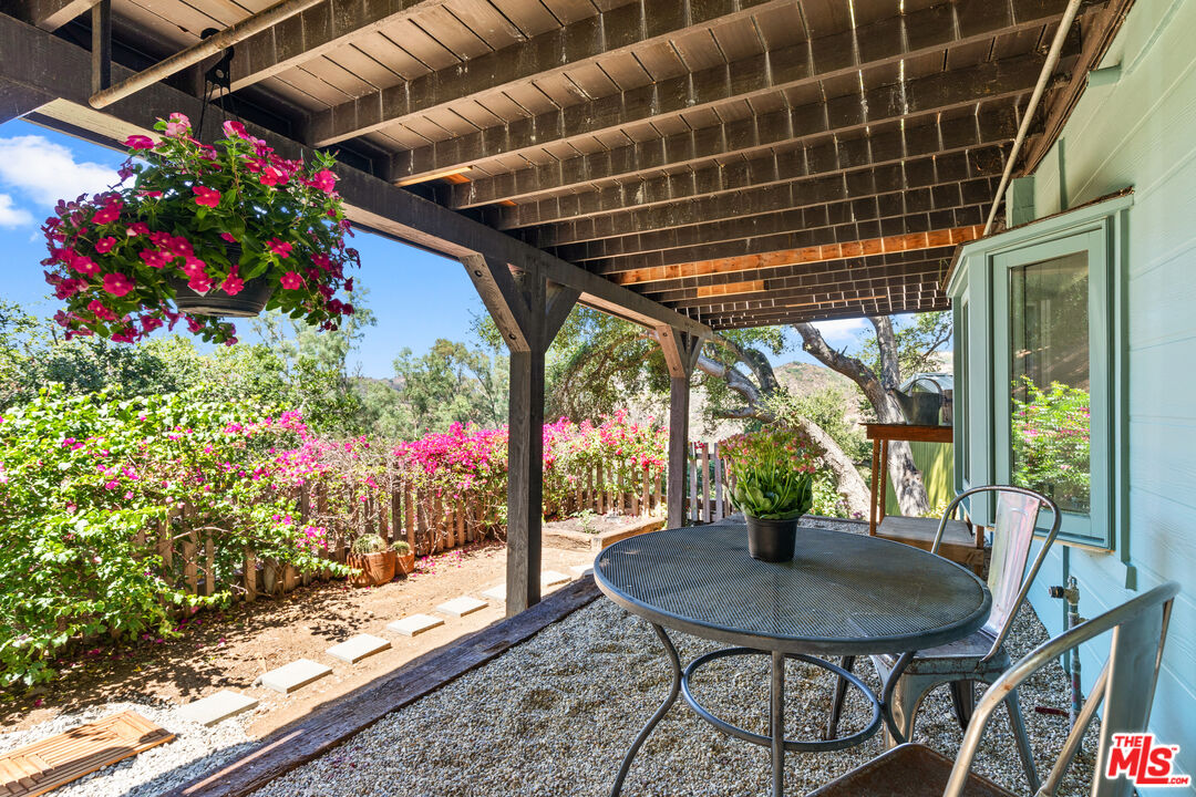1553 Penny Road Topanga, CA 90290 - Photo 19 of 23 a view of a porch with furniture and flowers
