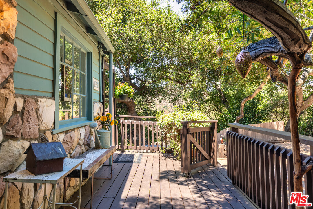 1553 Penny Road Topanga, CA 90290 - Photo 2 of 23 a view of balcony with wooden floor and outdoor seating