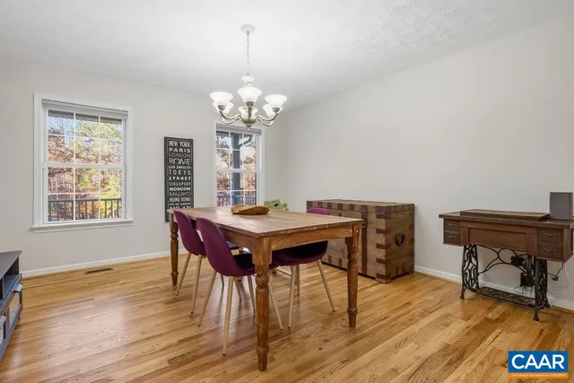 a view of a dining room with furniture wooden floor and chandelier