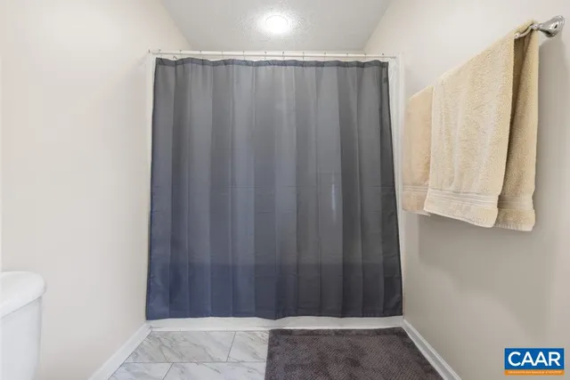 a view of a bathroom with shower and a window