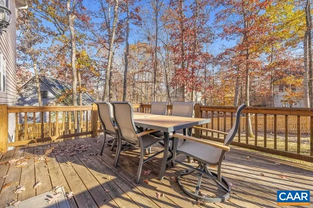 a view of balcony with wooden floor and outdoor seating