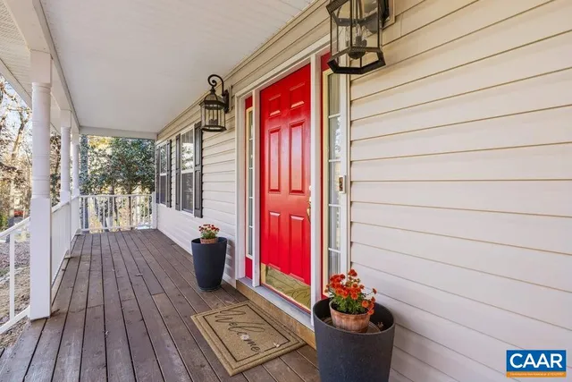 a view of balcony with two chairs and a potted plant