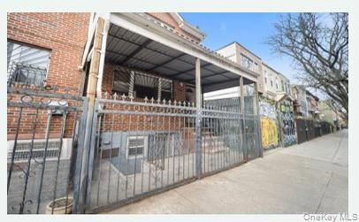 1101 Greene Avenue Brooklyn, NY 11221 - Photo 3 of 14 a view of a house with a wooden fence
