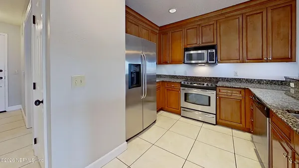 a kitchen that has a sink stove and cabinets