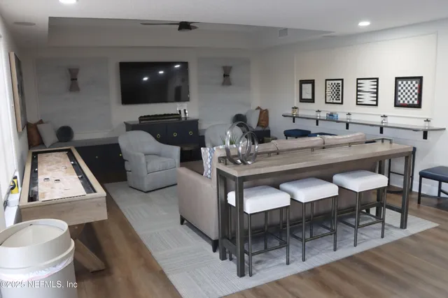 a view of a dining room with furniture and wooden floor