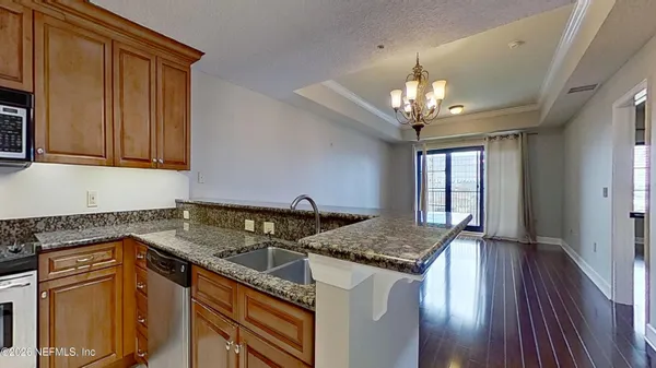 a view of a refrigerator in kitchen and white cabinets