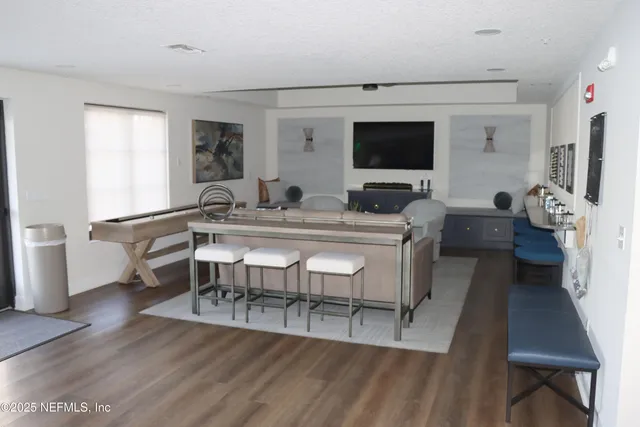 a living room with furniture and a chandelier