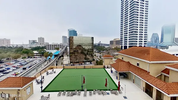 an aerial view of a tennis ground with large trees
