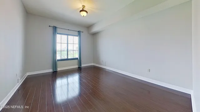 a view of a refrigerator in kitchen and white cabinets