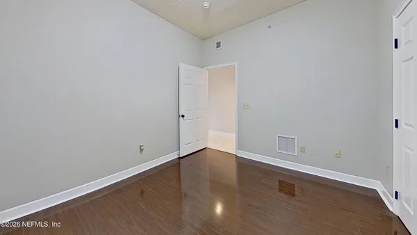a view of room with wooden floor