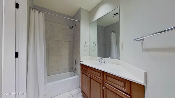 a bathroom with a shower and a sink
