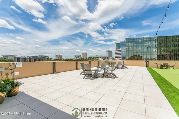 a view of a chairs and table in the back yard