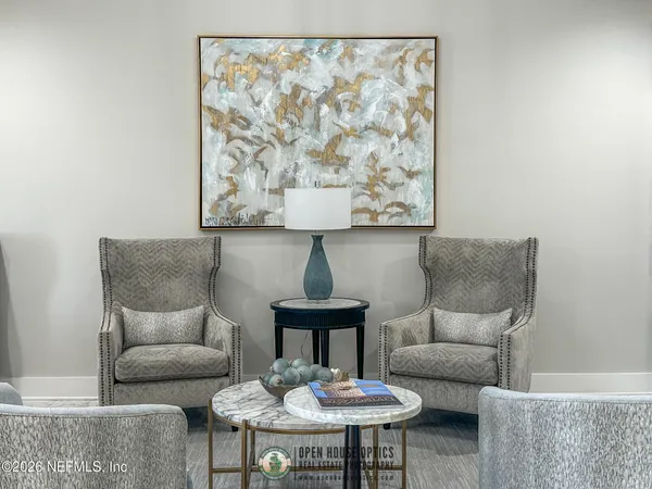a living room with furniture and a chandelier