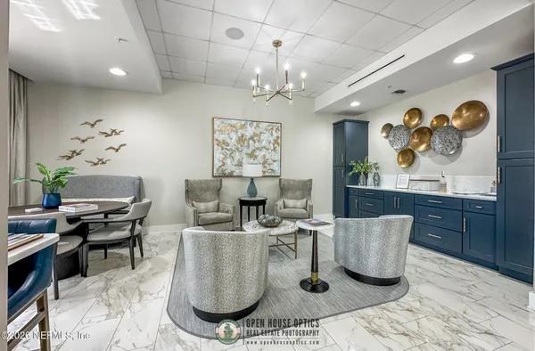a large white kitchen with a large window