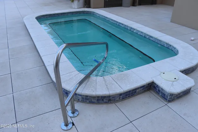 a kitchen with granite countertop white cabinets and sink