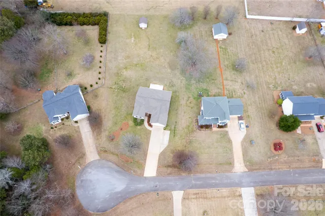 an aerial view of a house with a swimming pool