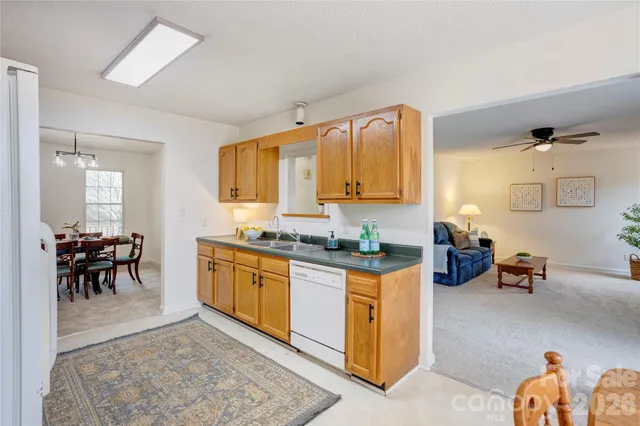 a kitchen with sink a table and chairs in it