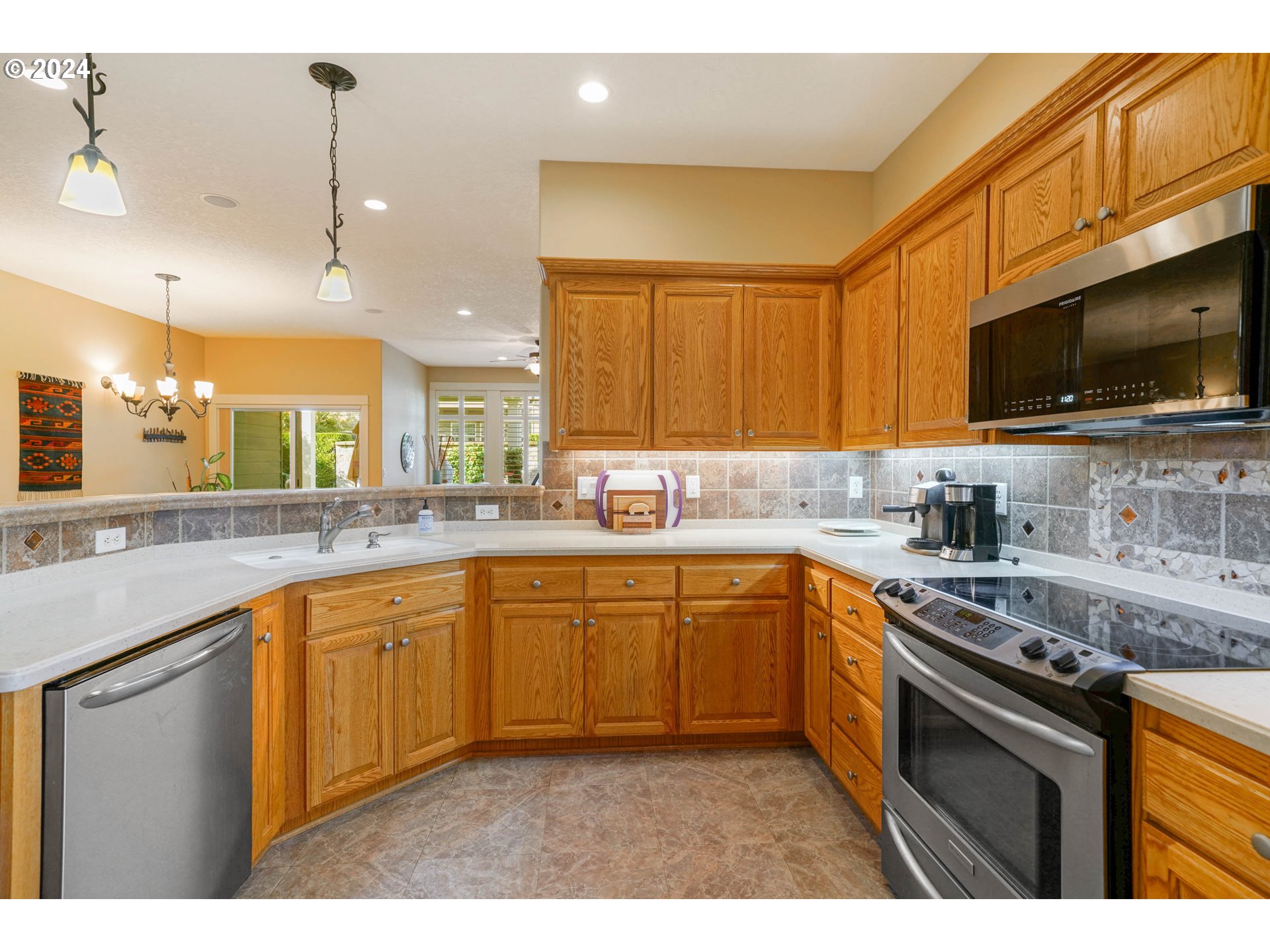 2155 Southeast Rhododendron Avenue Dallas, OR 97338 - Photo 19 of 40 a kitchen with stainless steel appliances granite countertop a sink a stove and cabinets