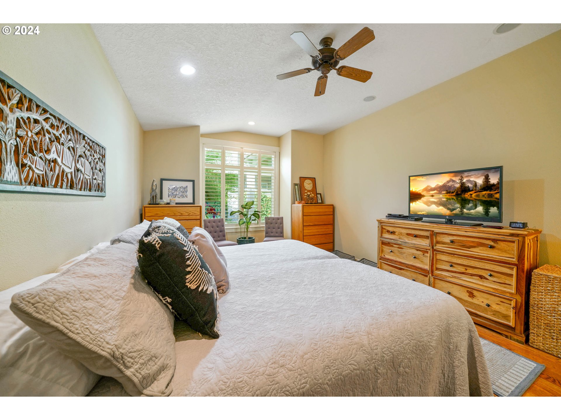 2155 Southeast Rhododendron Avenue Dallas, OR 97338 - Photo 29 of 40 a bedroom with a bed and wooden floor