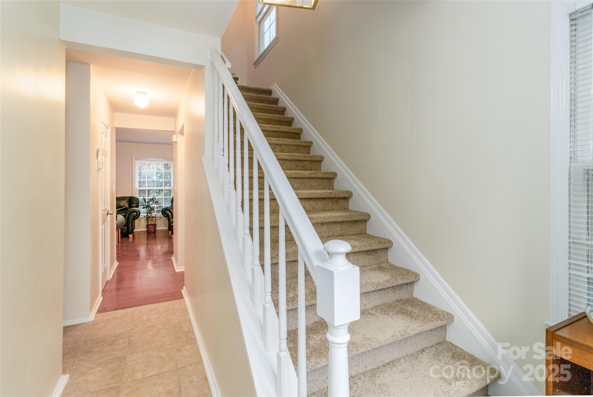 8300 Knights Bridge Road Charlotte, NC 28210 - Photo 12 of 47 a view of staircase with wooden floor and a rug