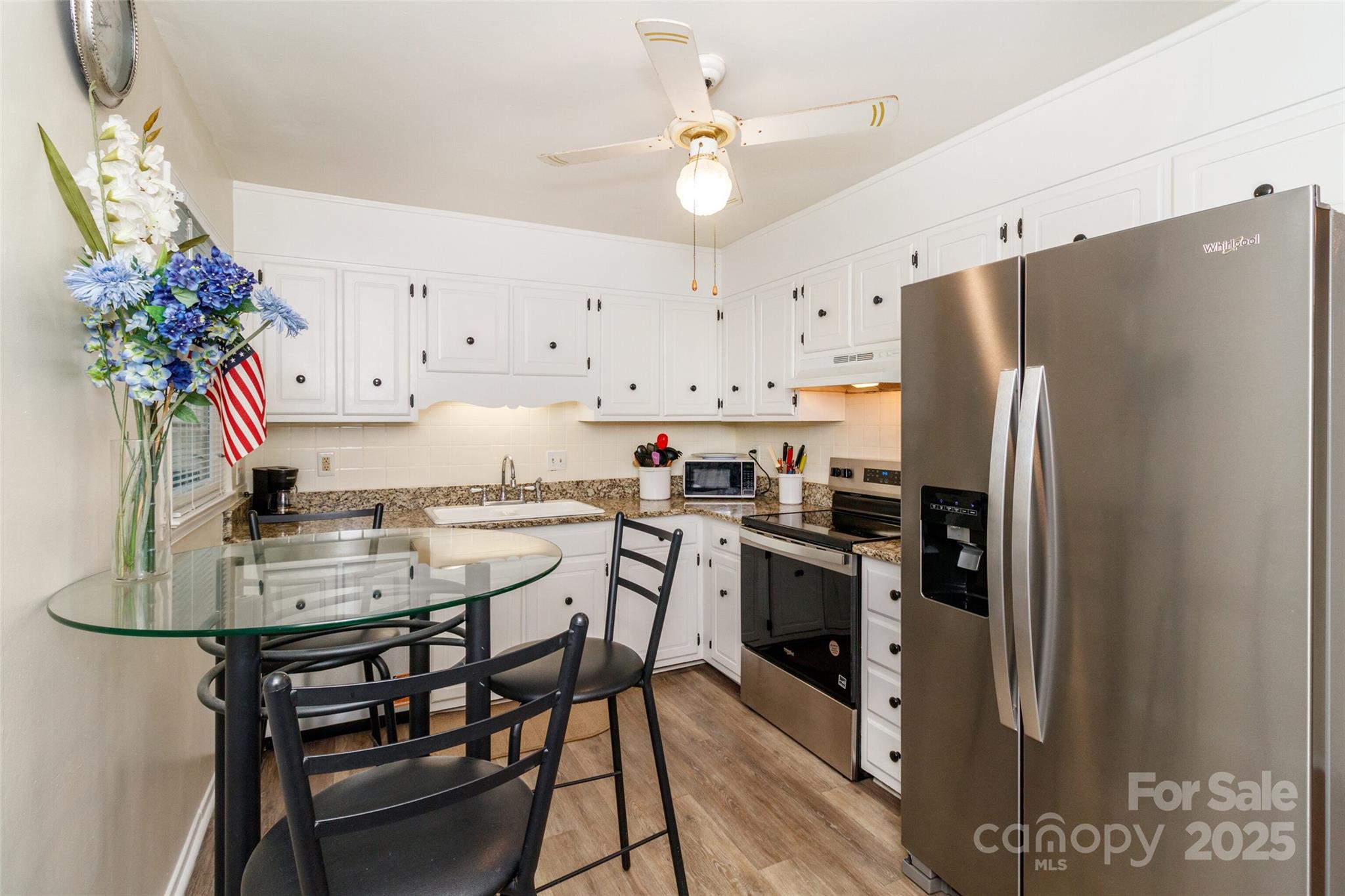 8300 Knights Bridge Road Charlotte, NC 28210 - Photo 14 of 47 a kitchen with stainless steel appliances a refrigerator a stove a sink and chairs