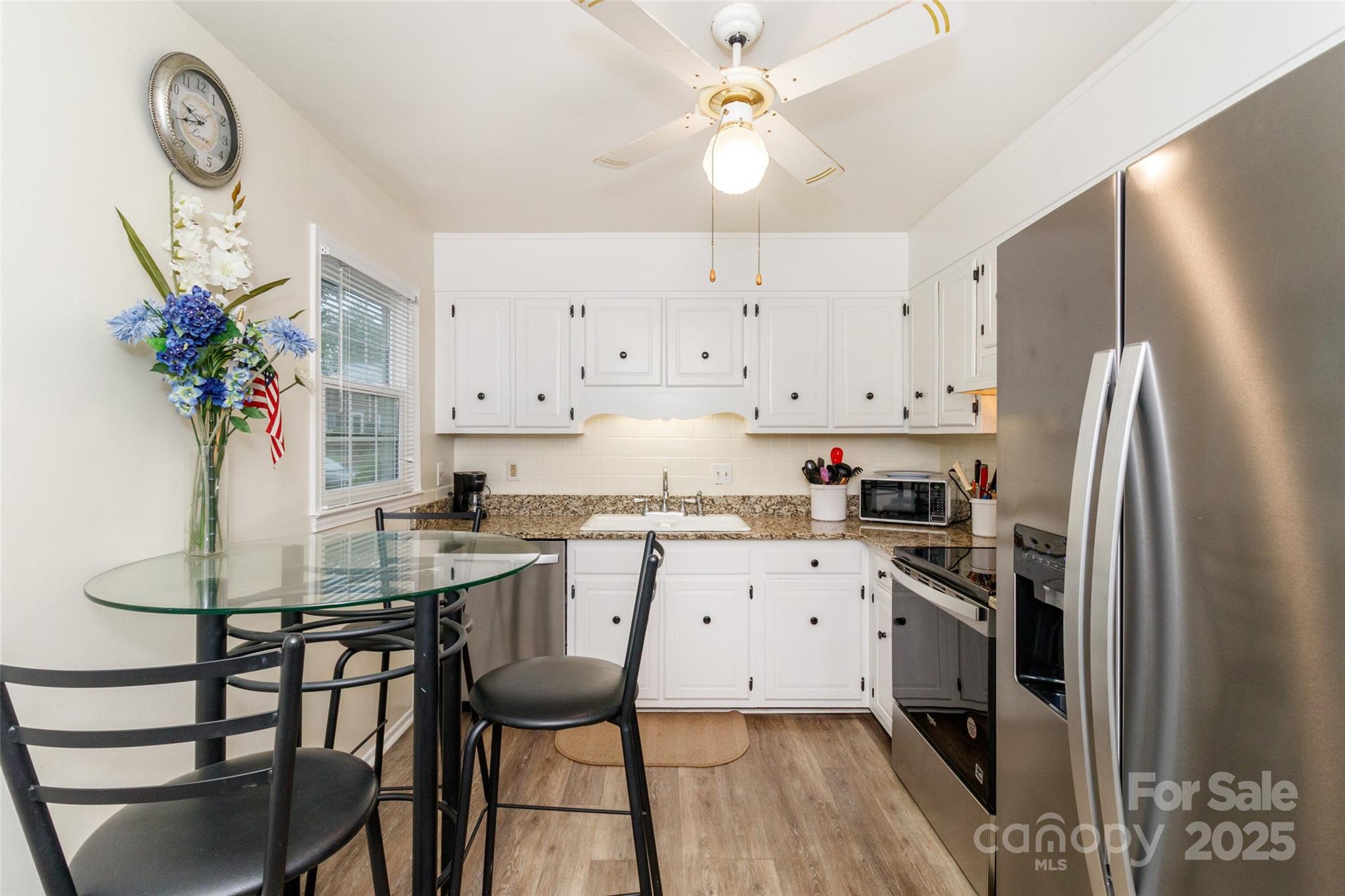 8300 Knights Bridge Road Charlotte, NC 28210 - Photo 15 of 47 a kitchen with stainless steel appliances a stove a sink island and cabinets