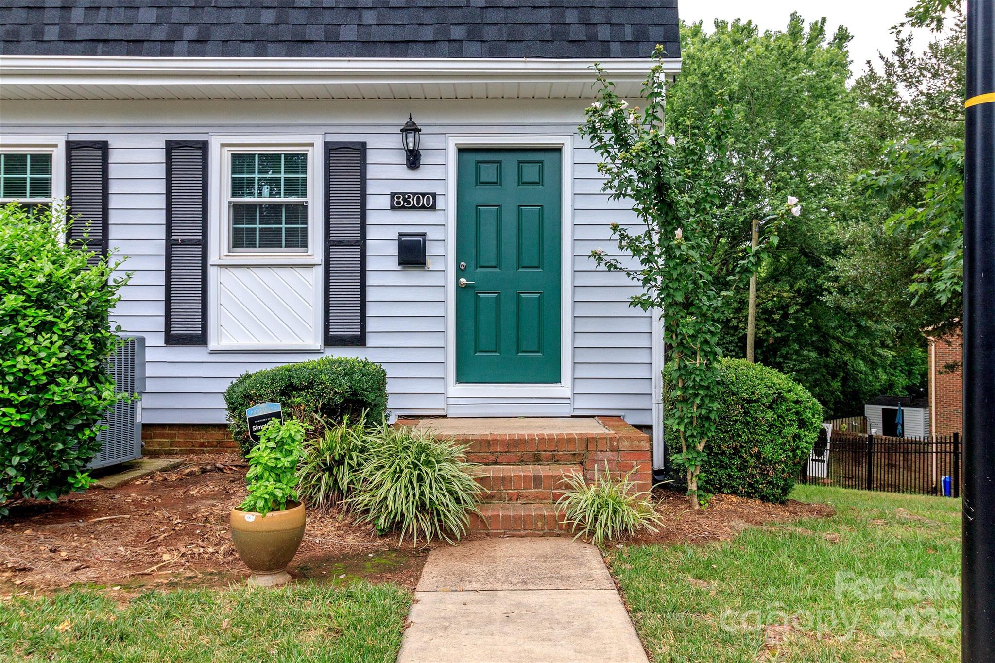 8300 Knights Bridge Road Charlotte, NC 28210 - Photo 2 of 47 a front view of a house with garden