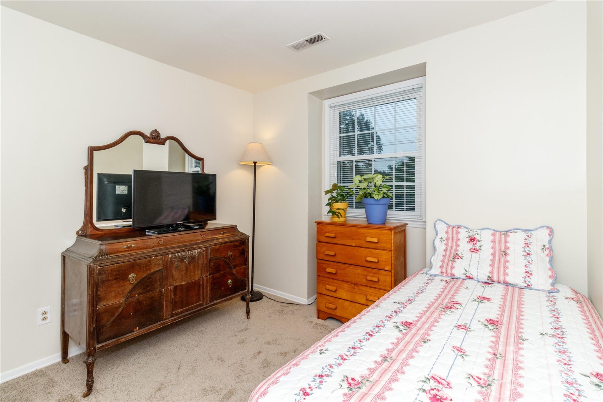 8300 Knights Bridge Road Charlotte, NC 28210 - Photo 27 of 47 a bedroom with a bed and a television in it